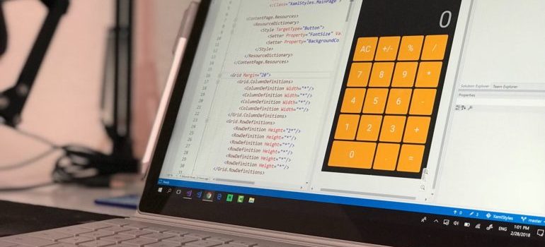 Calculator and coding on a laptop screen