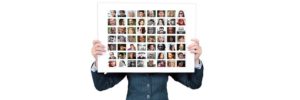 Woman holding a panel with small images of different people - double your website traffic with the help of others.