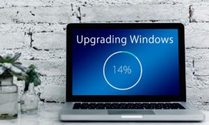 Laptop screen showing a 14% Windows upgrade in progress