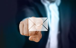 Businessman clicking on Email icon.