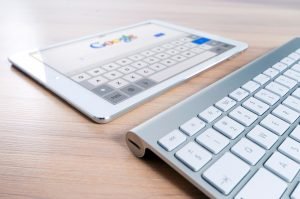 Tablet and keyboard with Google homepage.