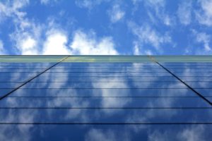 Glass business building with blue sky above