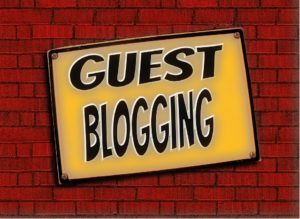 Guest blogging written in black letters ona brick wall.