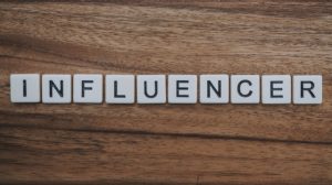 the word influencer written with white dices