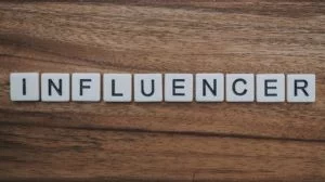 the word influencer written with white dices