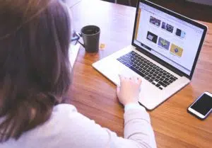A woman accessing a blog on a laptop.