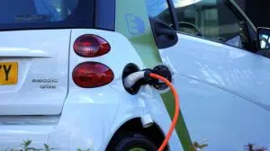 An electric car charging at the charge station.
