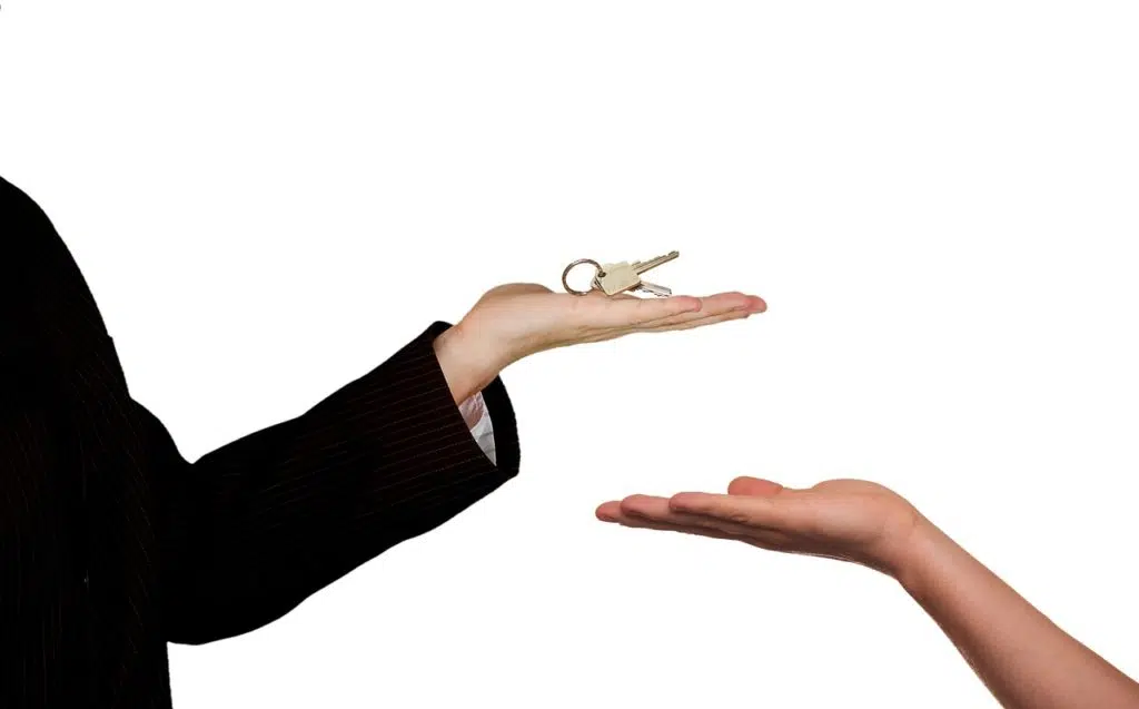 Person offering keys to other person
