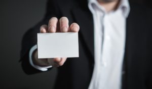 A businessman showing his blank business card.