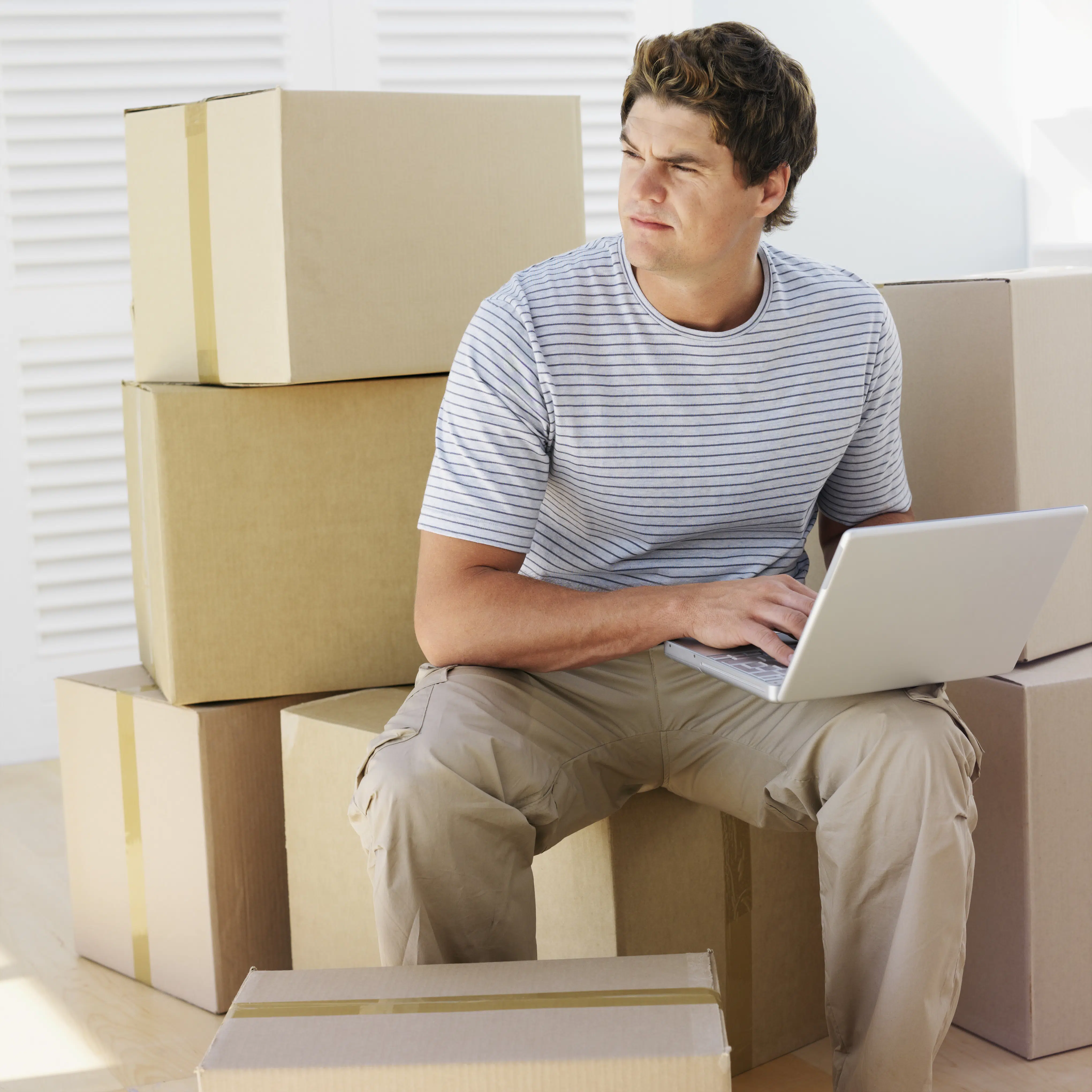 Person surrounded by moving boxes