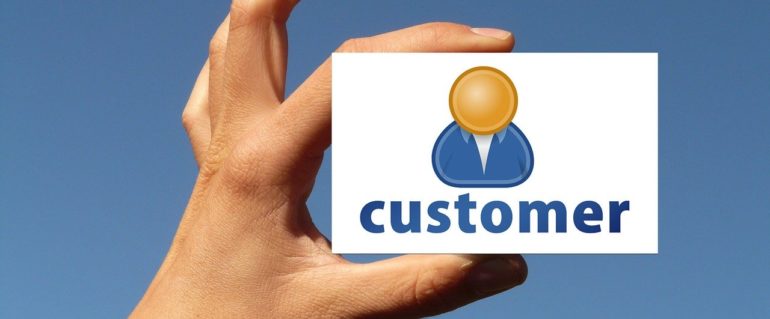 Hand holding a Customer card.
