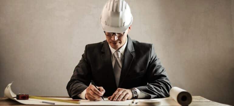 An image of a businessman with a protective helmet