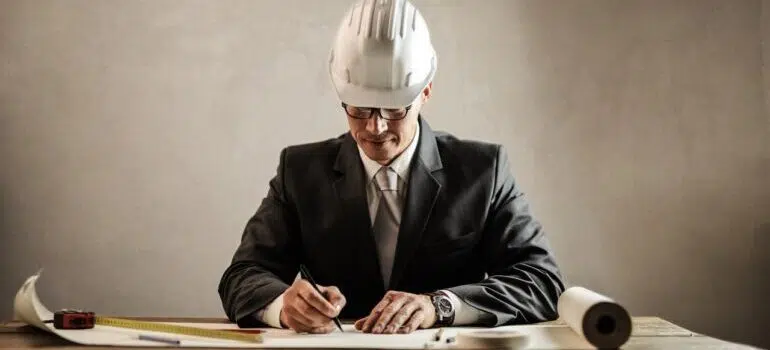 An image of a businessman with a protective helmet