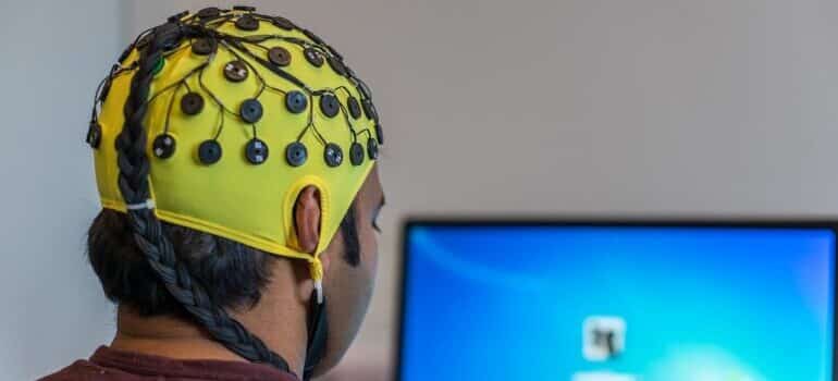 Person with an EEG neuro net on his head