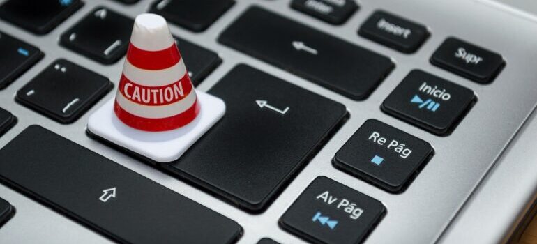 Image of a keyboard with traffic Caution cone on the Enter button