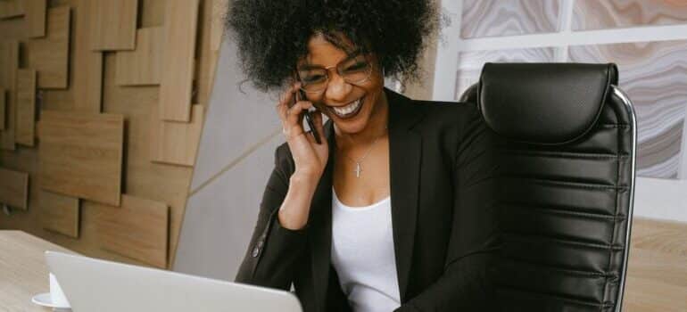 A woman talking on her phone and smiling.