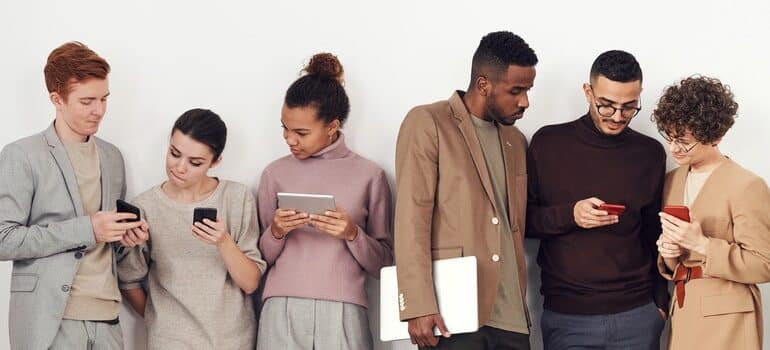 Young people looking at their phones.