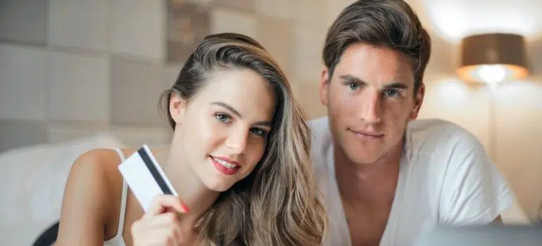 Young couple holding a credit card.