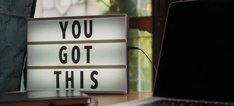 A lightbox sith the words "you got this" next to a laptop.