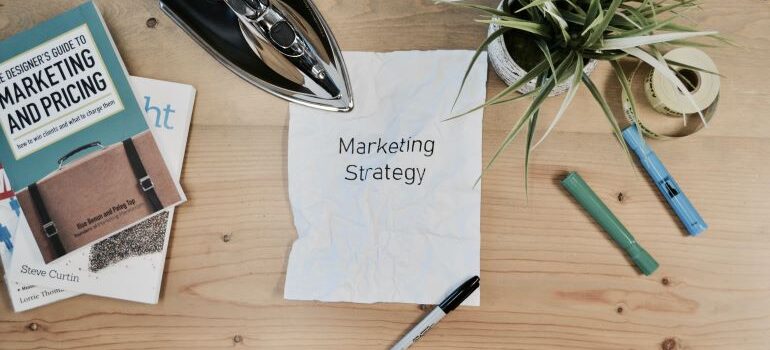 A paper on a desk with "marketing strategy" written on it