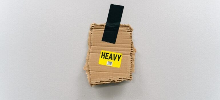 A piece of cardboard with the word "heavy" written on it.