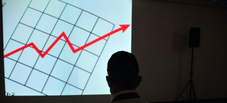 A business owner examines a graph depicting the growth of his company's value.