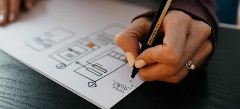 A person drawing a design for a website