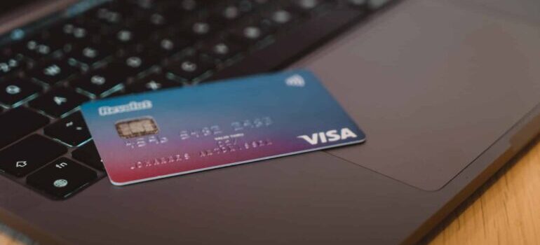 A Visa credit card on a laptop keyboard.
