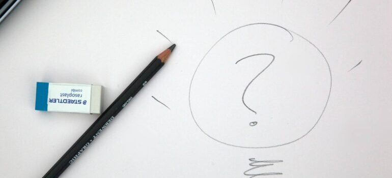 Question mark within a light bulb that's been drawn using a pencil.