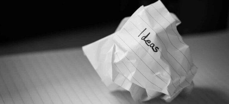 Scrunched piece of paper with the word ''ideas'' on it.