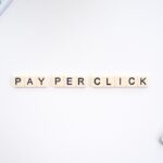 Blocks that spell out the phrase ''pay per click'' representing the use PPC advertising to help grow your startup