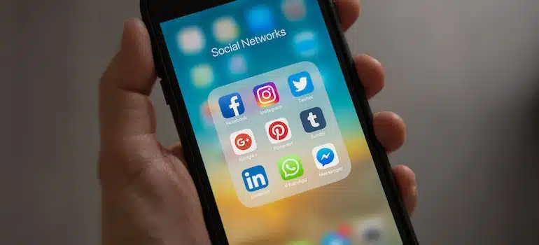 a phone with social media apps on the screen