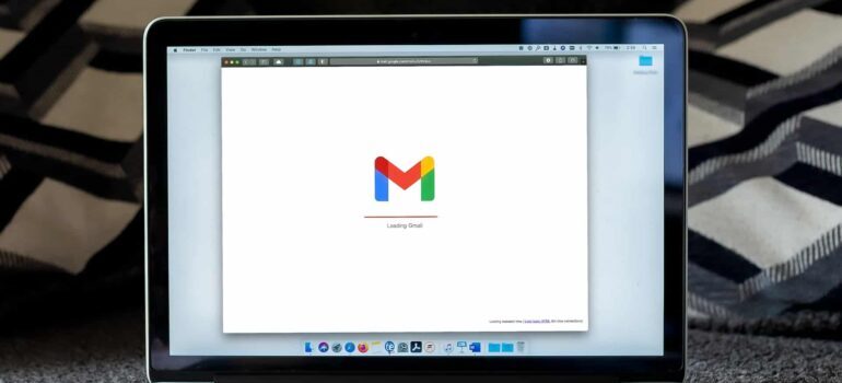 A laptop screen displaying the Gmail logo.