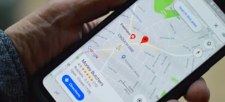 Person holding a phone with Google Maps opened on it