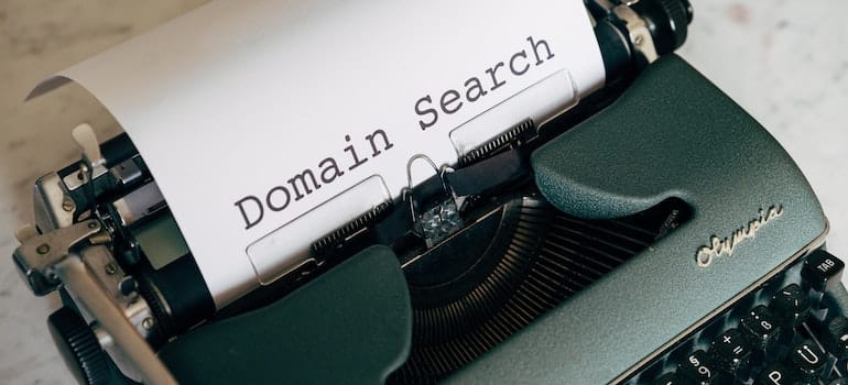 A typewriter with words domain search written