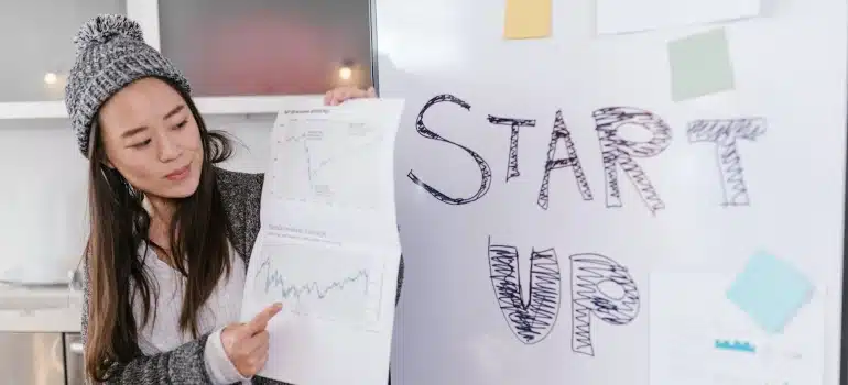 Person holding a paper with Start Up written on it
