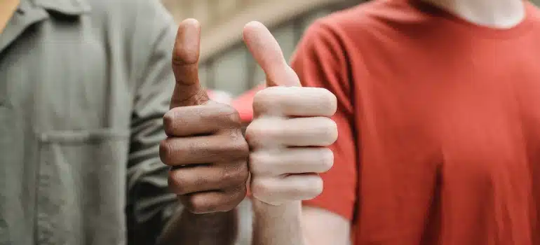 Two people holding thumbs up