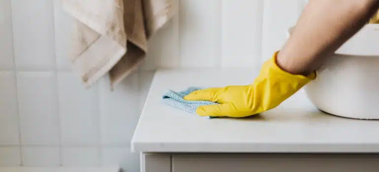 person cleaning a counter