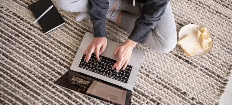 a person using a laptop to learn about the benefits if post-move follow-up emails