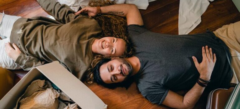 Couple laying on the floor relaxing after a long distance move