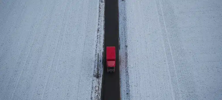 A moving truck on the road in winter