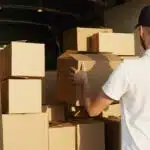 A mover stacking boxes into a van and thinking about how moving companies can address homeowners' biggest concerns
