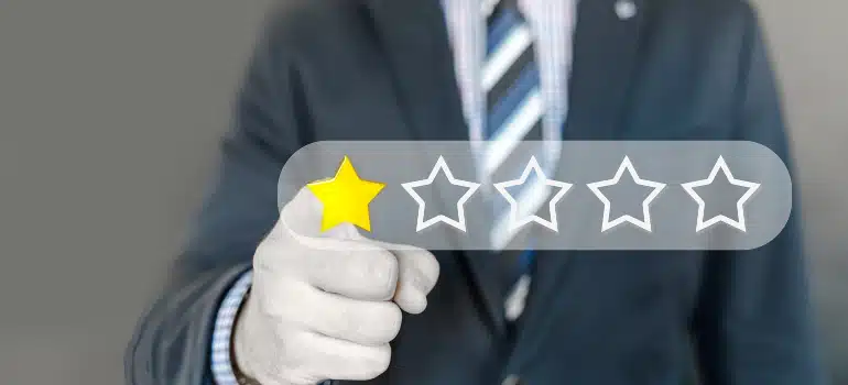 A man pointing to a one-star rating, underscoring why your moving company needs a great About Us page for reputation management.