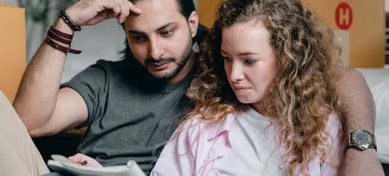 a couple trying to calculate moving costs on paper