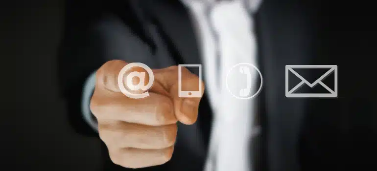 Person pointing at email icons, highlighting how to personalize emails to meet the specific needs of different client segments for better engagement.