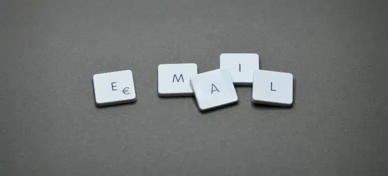 Tiles spelling 'EMAIL' on a gray background, illustrating how to personalize emails for effective communication.