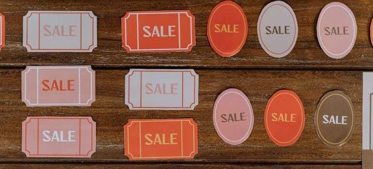 colorful sale signs on wooden background